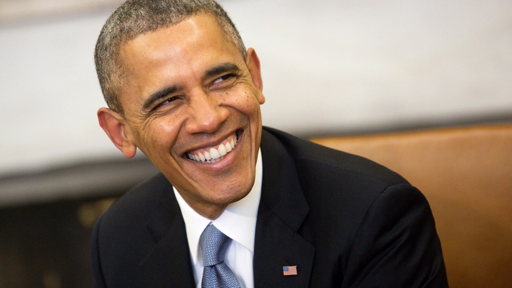 President Barack Obama smiles in the Oval Office at the White House on Feb. 11, 2014 in Washington, D.C. (Photo by Andrew Harrer/Pool/Getty)