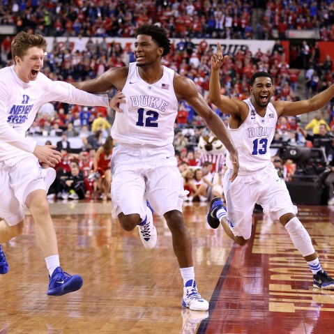 Justise Winslow #12 and Matt Jones #13 of the Duke Blue Devils celebrate with teammates after defeating the Wisconsin Badgers during the NCAA Men's Final Four National Championship on April 6, 2015 in Indianapolis, Ind. (Photo by Andy Lyons/Getty)