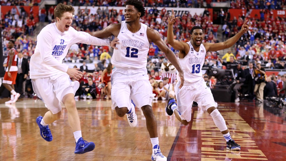 Justise Winslow #12 and Matt Jones #13 of the Duke Blue Devils celebrate with teammates after defeating the Wisconsin Badgers during the NCAA Men's Final Four National Championship on April 6, 2015 in Indianapolis, Ind. (Photo by Andy Lyons/Getty)
