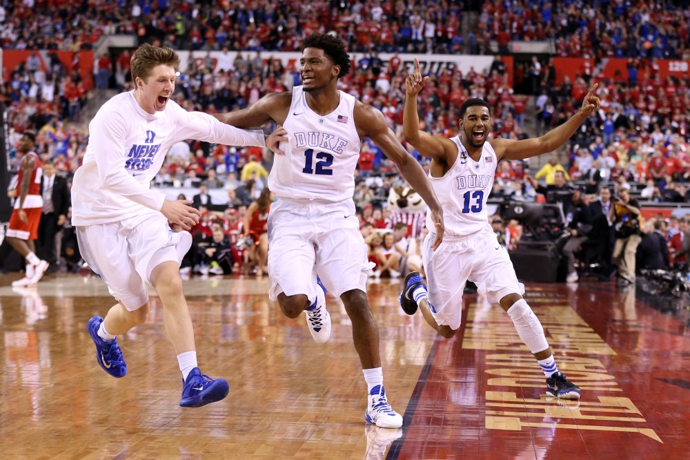 Justise Winslow #12 and Matt Jones #13 of the Duke Blue Devils celebrate with teammates after defeating the Wisconsin Badgers during the NCAA Men's Final Four National Championship on April 6, 2015 in Indianapolis, Ind. (Photo by Andy Lyons/Getty)