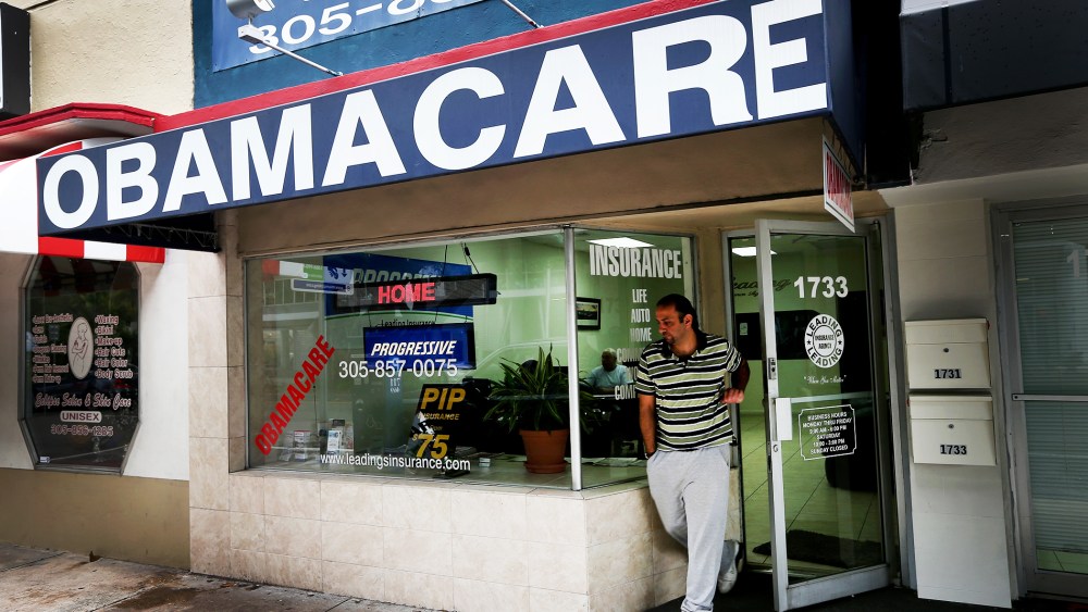 Baseel Farah walks out of Leading Insurance Agency as the insurance agency helps enroll people in health insurance plans under the Affordable Care Act in Miami, Feb. 13, 2014.