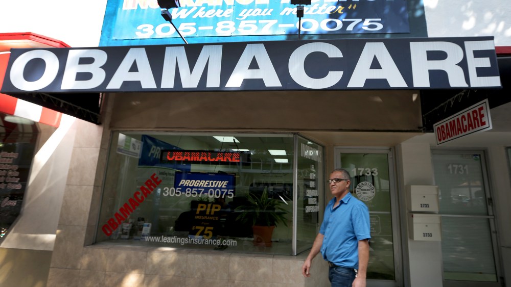Hisham Uadadeh walks out of Leading Insurance Agency after  enrolling in a health insurance plan under the Affordable Care Act on February 13, 2014 in Miami, Florida.
