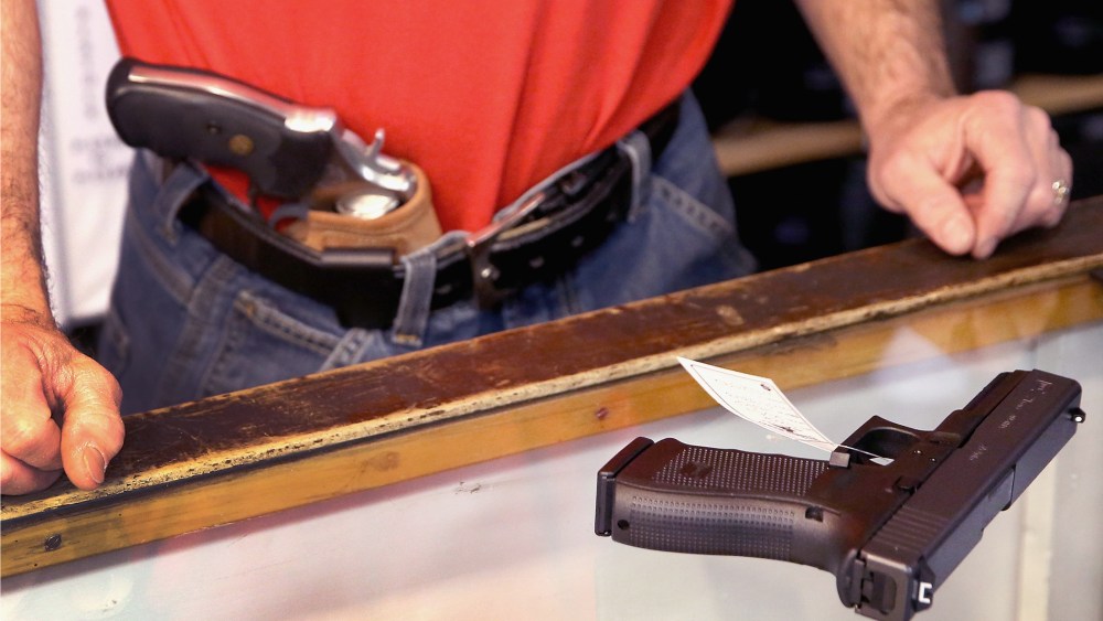 Dan Egar helps a customer shop for a handgun on February 13, 2014 in Tinley Park, Illinois.