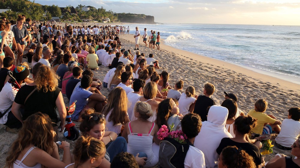 Several hundreds of people gather on the beach in Les Aigrettes, on the western coast of the French Indian Ocean island of La Reunion, on April 12, 2015 to pay tribute to a 13-year-old boy who was attacked and killed by a shark.