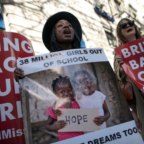 Women hold a signs as other protesters gather outside Nigeria House to mark the one year anniversary since a group of Nigerian schoolgirls were abducted on April 14, 2015 in London, England. (Photo by Dan Kitwood/Getty)
