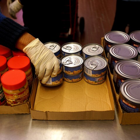 A volunteer distributes food at CAMBA's Beyond Hunger Emergency Food Pantry on Feb. 18, 2014 in the Brooklyn borough of New York City.