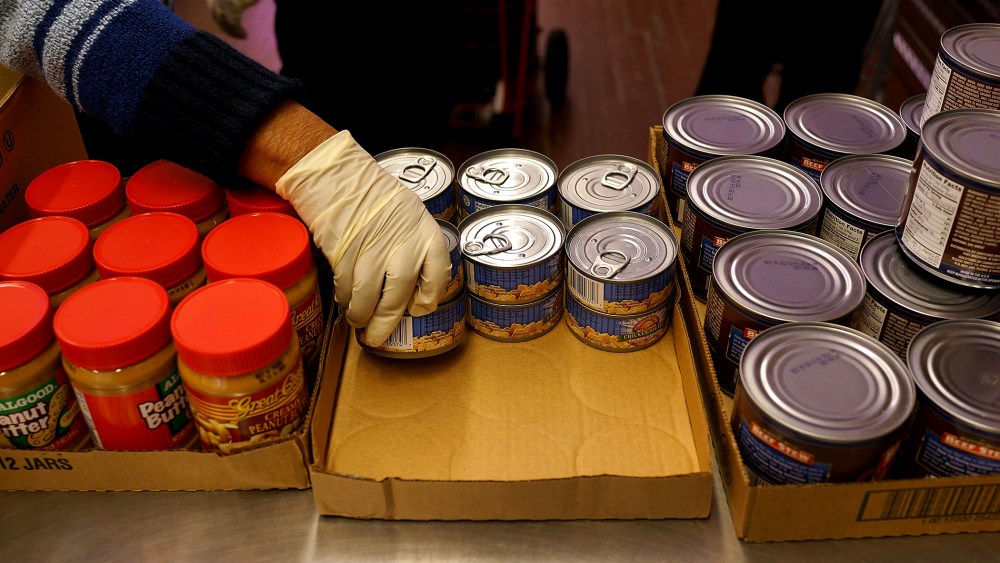 A volunteer distributes food at CAMBA's Beyond Hunger Emergency Food Pantry on Feb. 18, 2014 in the Brooklyn borough of New York City.