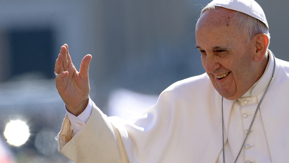 Pope Francis salutes the crowd as he arrives for his weekly general audience in St Peter's square at the Vatican on April 22, 2015. (Photo by Filippo Monteforte/AFP/Getty)