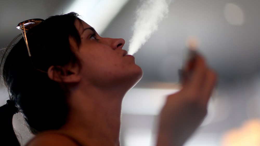 Yenisley Dieppa tries different flavors as she purchases an electronic cigarette at the Vapor Shark store on Feb. 20, 2014 in Miami, Florida.