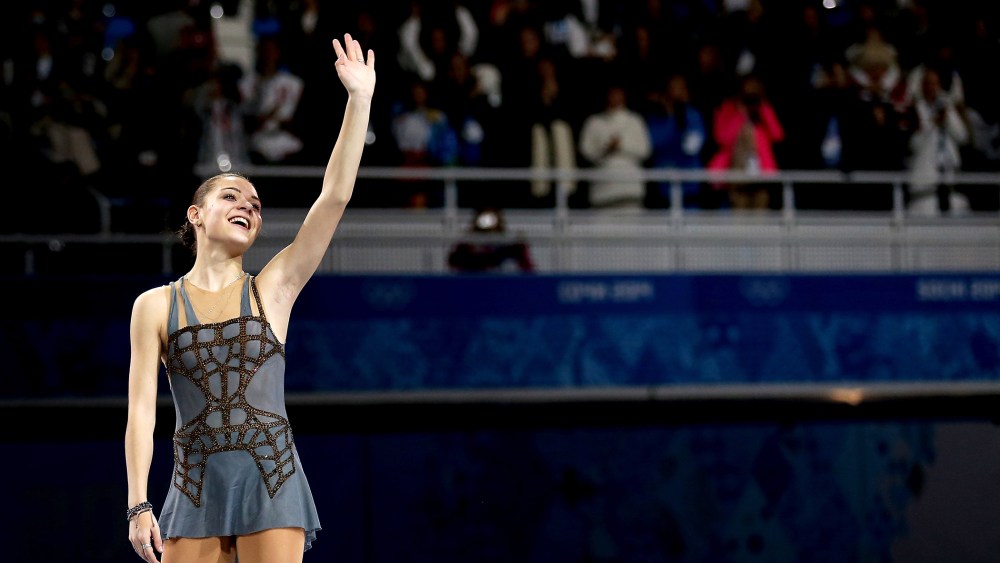 Gold medalist Adelina Sotnikova of Russia celebrates on the podium during the flower ceremony for the Ladies' Figure Skating, Feb. 20, 2014.