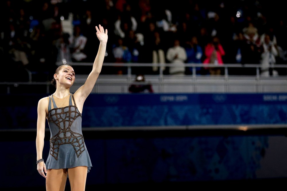 Gold medalist Adelina Sotnikova of Russia celebrates on the podium during the flower ceremony for the Ladies' Figure Skating, Feb. 20, 2014.