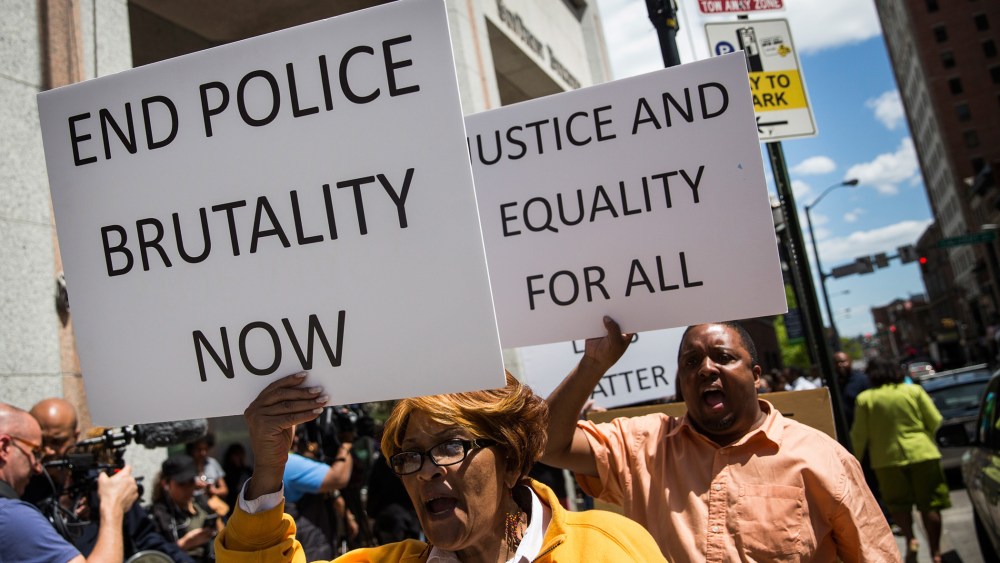 People participate in a rally for the family of Freddie Gray outside the Maryland state's attorney's office on April 29, 2015 in Baltimore, Md. (Photo by Andrew Burton/Getty)