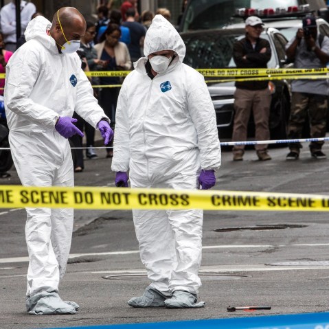 Crime scene investigators inspect a hammer used in an attack on a police officer on May 13, 2015 in New York, N.Y. (Photo by Andrew Burton/Getty)