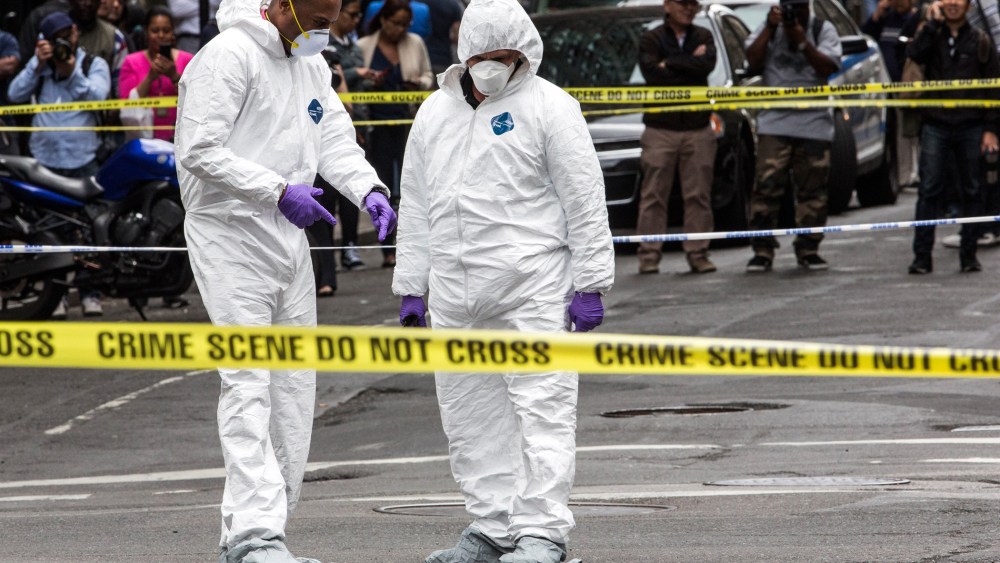 Crime scene investigators inspect a hammer used in an attack on a police officer on May 13, 2015 in New York, N.Y. (Photo by Andrew Burton/Getty)