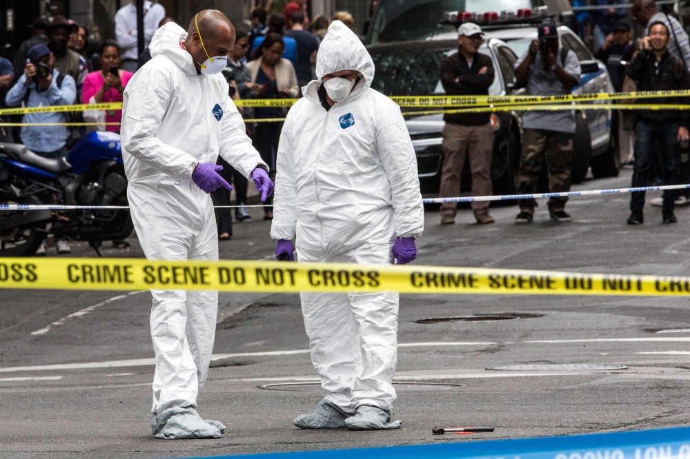 Crime scene investigators inspect a hammer used in an attack on a police officer on May 13, 2015 in New York, N.Y. (Photo by Andrew Burton/Getty)
