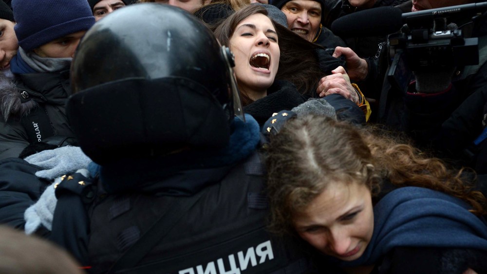Nadezhda Tolokonnikova (rear) and Maria Alyokhina (front) are taken into custody by Russian police during a protest on Feb. 24, 2014.