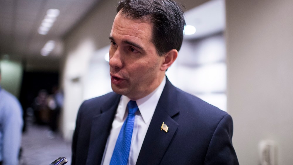 Wisconsin Governor Scott Walker speaks with a reporter in Washington, Feb. 22, 2014.