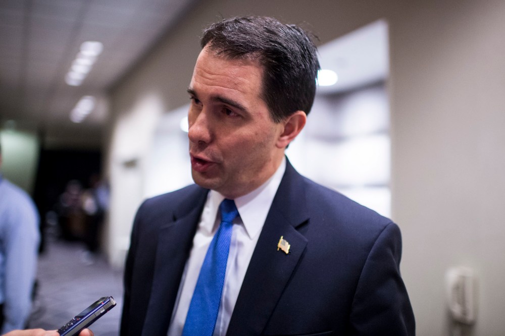 Wisconsin Governor Scott Walker speaks with a reporter in Washington, Feb. 22, 2014.