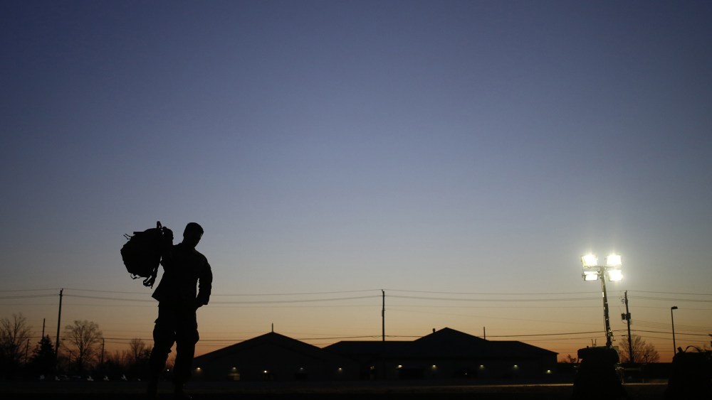 A soldier grabs his rucksack following a homecoming ceremony in Fort Knox, Kentucky.