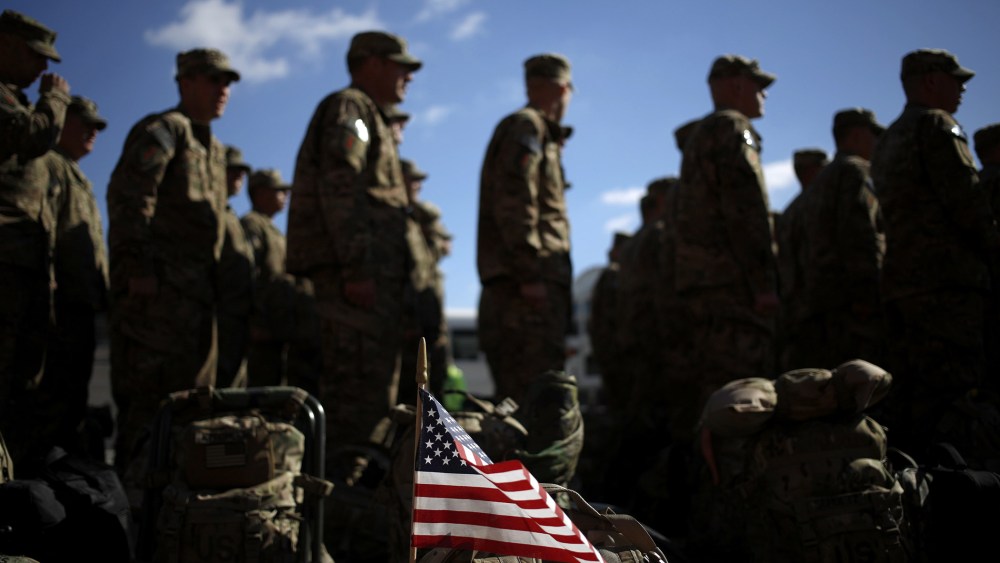 An American flag flies from the rucksack of a soldier outside a homecoming ceremony at Fort Knox on  Feb. 27, 2014 in Fort Knox, Ky.