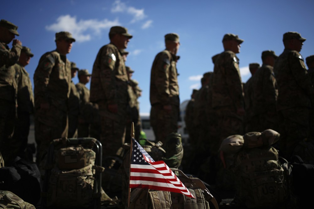 An American flag flies from the rucksack of soldier outside a homecoming ceremony on Fort Knox on Thursday, February 27, 2014 in Fort Knox, Ky.