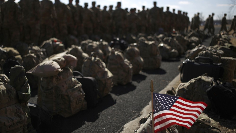 An American flag flies from the rucksack of soldier outside a homecoming ceremony on Fort Knox, Feb. 27, 2014 in Fort Knox, Ky.