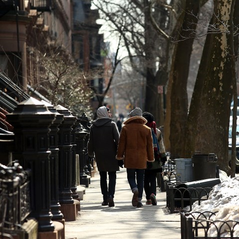 People walk down a street in the Fort Greene neighborhood of Brooklyn on Feb. 27, 2014.