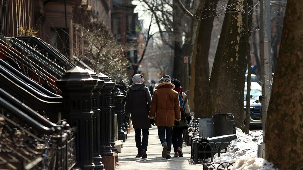 People walk down a street in the Fort Greene neighborhood of Brooklyn on Feb. 27, 2014.