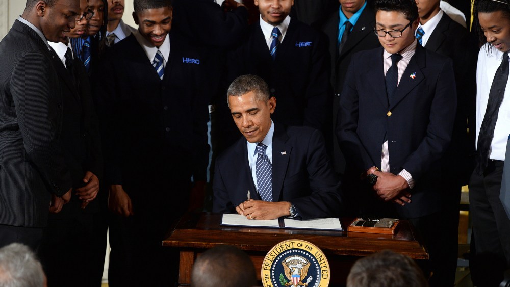 US President Barack Obama signs a presidential memorandum after speaking on his My Brothers Keeper initiative to expand opportunity for Americans in the East Room at the White House on Feb. 27, 2014 in Washington, D.C. (Photo by Jewel Samad/AFP/Getty)