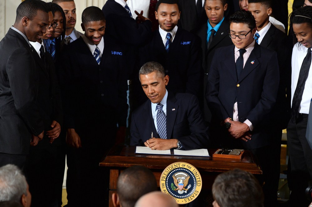 US President Barack Obama signs a presidential memorandum after speaking on his My Brothers Keeper initiative to expand opportunity for Americans in the East Room at the White House on Feb. 27, 2014 in Washington, D.C. (Photo by Jewel Samad/AFP/Getty)