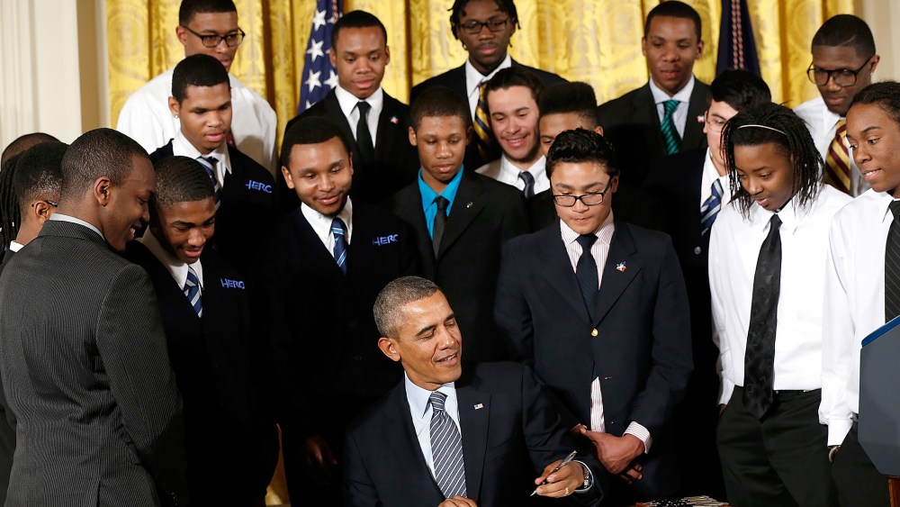 U.S. President Barack Obama signs an executive memorandum regarding the My Brother's Keeper Initiative, Feb. 27, 2014.
