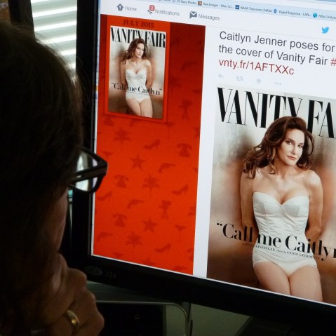 A journalist looks at Vanity Fair's Twitter site with the Tweet about Caitlyn Jenner, who will be featured on the July cover of the magazine. (Photo by Mladen Antonov/AFP/Getty)