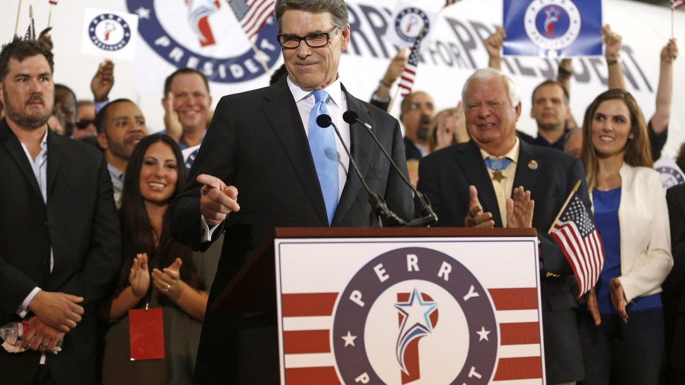 Former Texas Governor Rick Perry points to a supporter after announcing that he will run for president in 2016 June 4, 2015 in Dallas, Texas. (Photo by Ron Jenkins/Getty)