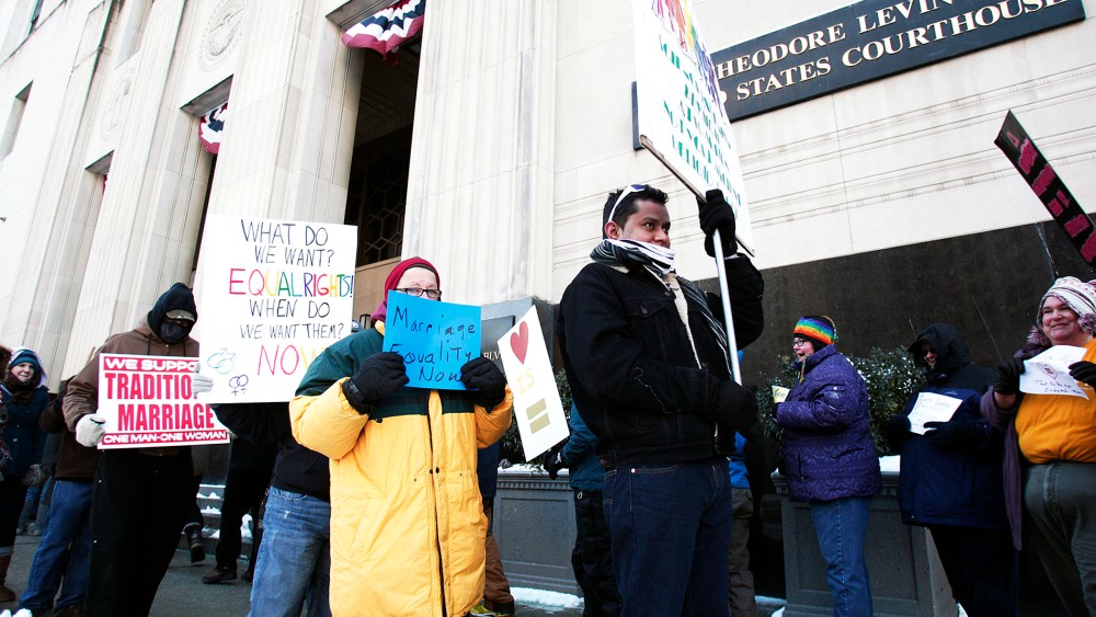 Pro-traditional marriage supporters protest next to gay marriage supporters in front of the U.S. Federal Courthouse in Detroit, Michigan, Mar. 3, 2014.