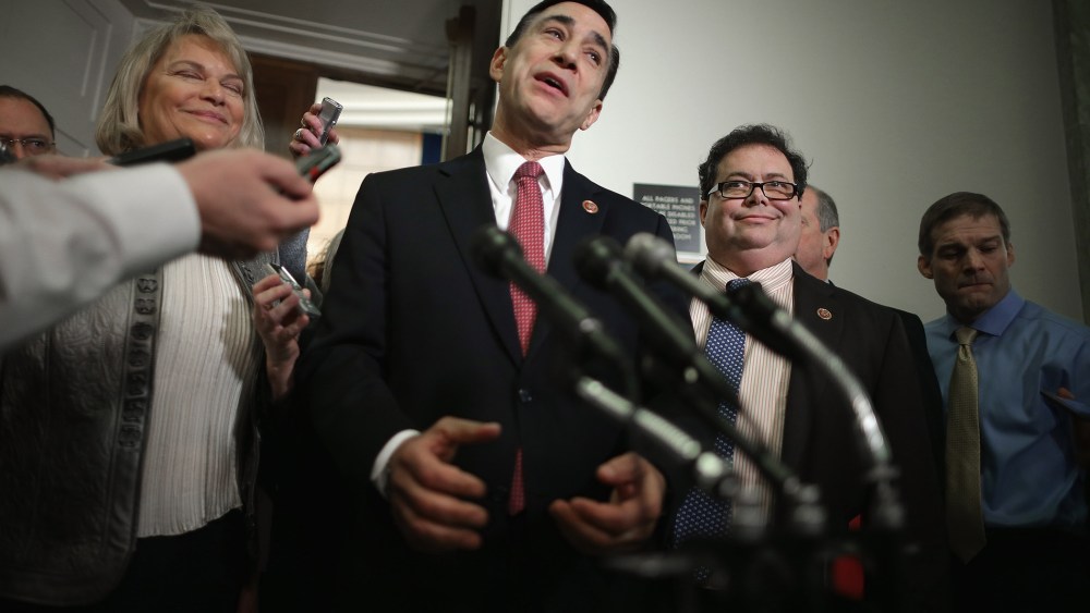 House Oversight and Government Reform Committee Chairman Darrell Issa (R-CA) (C) talks to reporters on Capitol Hill on March 5, 2014 in Washington, DC.