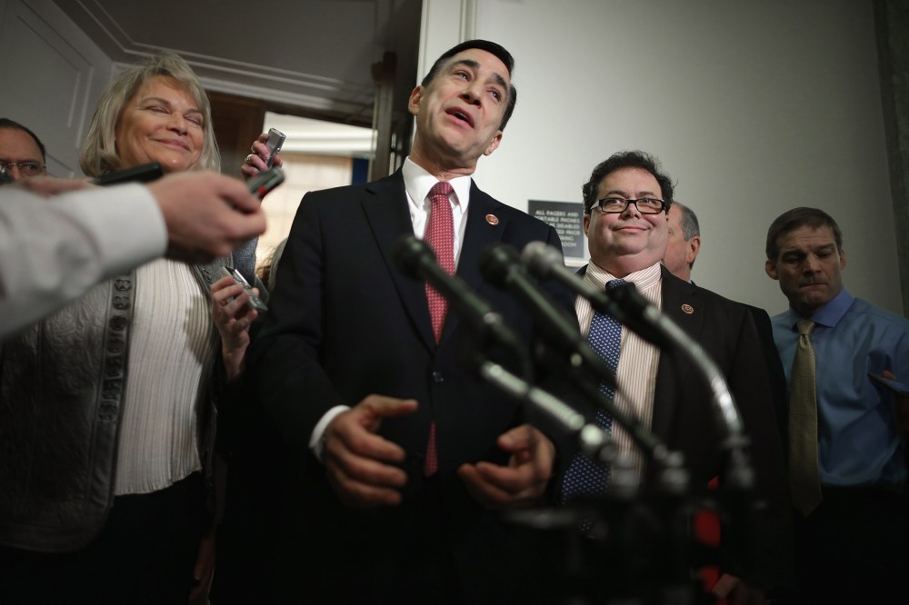 House Oversight and Government Reform Committee Chairman Darrell Issa (R-CA) (C) talks to reporters on Capitol Hill on March 5, 2014 in Washington, DC.