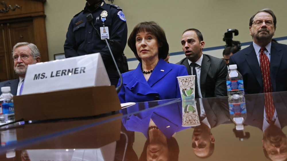Former Internal Revenue Service official Lois Lerner (C) exercises her Fifth Amendment right not to speak about the IRS targeting investigation, March 5, 2014.