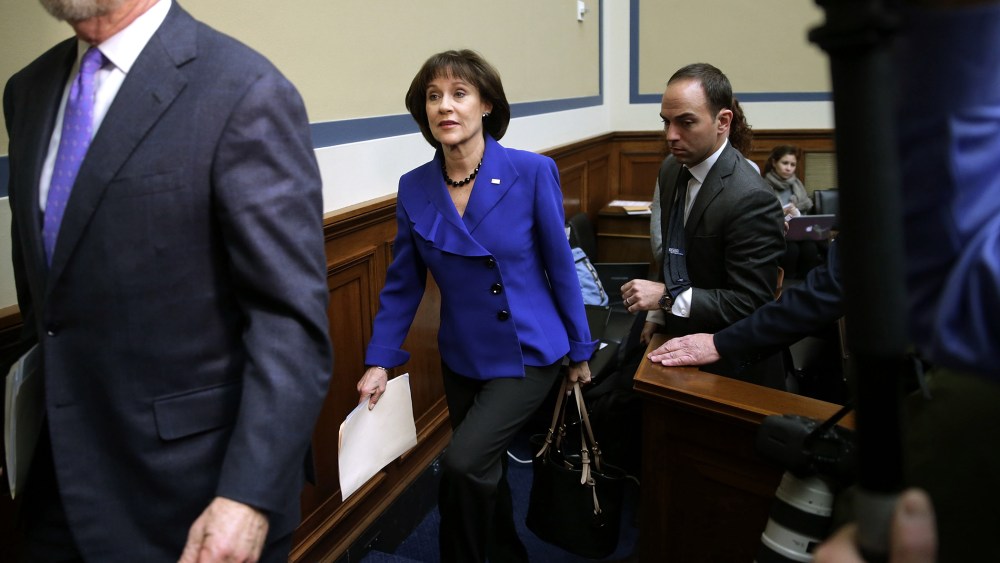 Former Internal Revenue Service official Lois Lerner (C) leaves a hearing in the Rayburn House Office Building on March 5, 2014 in Washington, DC.