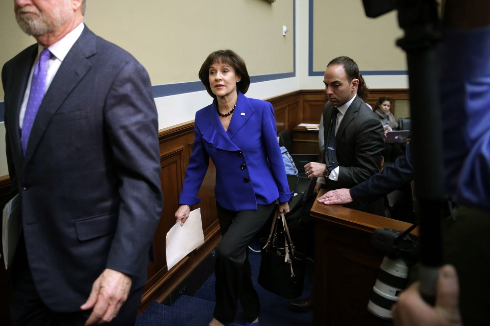 Former Internal Revenue Service official Lois Lerner (C) leaves a hearing in the Rayburn House Office Building on March 5, 2014 in Washington, DC.