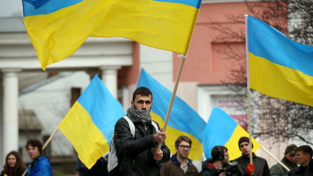Pro-Ukrainian sympathizers, waving Ukrainian flags and chanting "Russian Soldiers Out Of Crimea," "Glory To Ukraine" and "Crimea Ukraine," gather on March 8, 2014 in Simferopol, Ukraine.