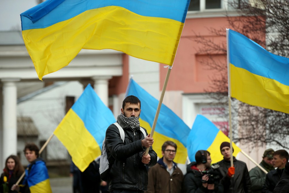 Pro-Ukrainian sympathizers, waving Ukrainian flags and chanting "Russian Soldiers Out Of Crimea," "Glory To Ukraine" and "Crimea Ukraine," gather on March 8, 2014 in Simferopol, Ukraine.