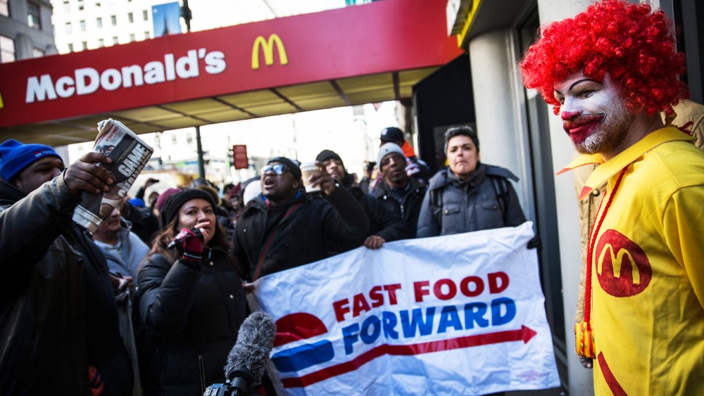 A man dressed as the McDonald's mascot participates in a protest for higher wages for fast food workers on March 18, 2014 in New York City.