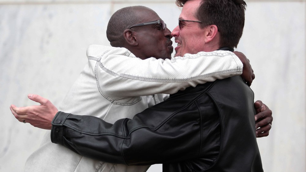 Roland Smith (L) and Paul Mattson (R) of Farmington Hills, MI., kiss after getting married at the Oakland County Courthouse on March 22, 2014 in Pontiac, Mich.