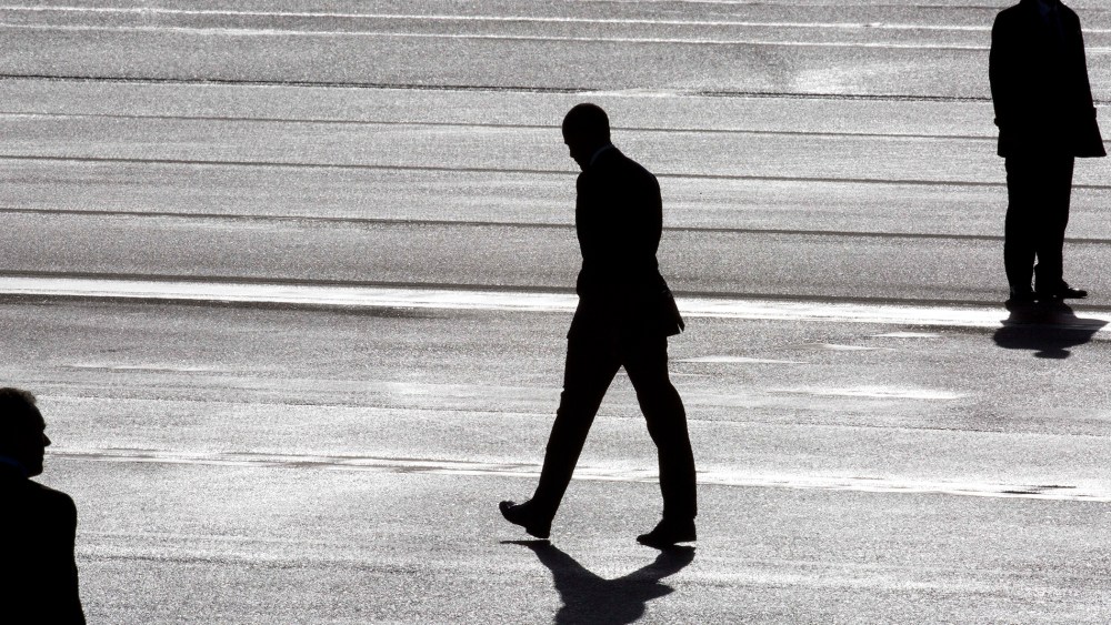 President Barack Obama (C) and two secret service agents are silhouetted as he walks towards Marine One helicopter as they arrive at Schiphol Amsterdam Airport