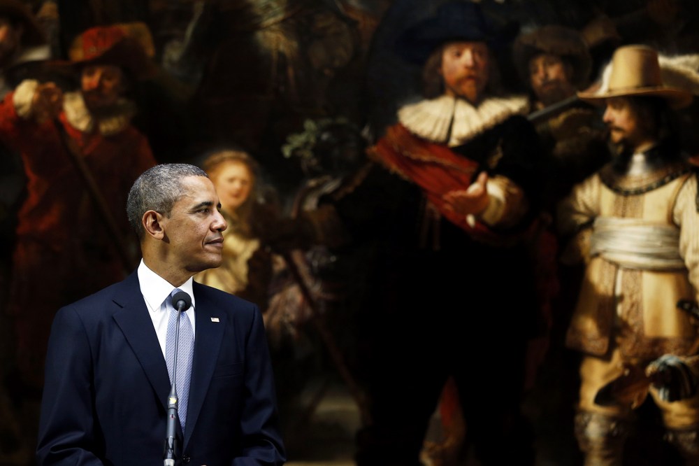 President Barack Obama looks over at the Dutch Prime Minister during a joint press conference held in front of Rembrandt's painting "The Night Watch"