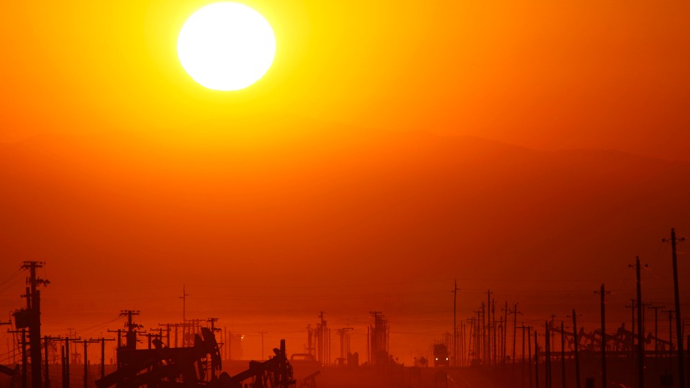 The sun rises over an oil field over the Monterey Shale formation where gas and oil extraction using hydraulic fracturing, or fracking, is on the verge of a boom on March 24, 2014 near Lost Hills, Calif. (Photo by David McNew/Getty)