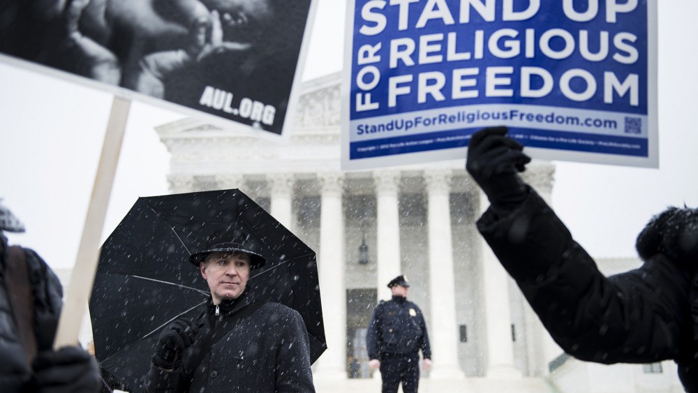 People who support Hobby Lobby's choice to withhold contraceptive healthcare coverage from their employees rally outside the US Supreme Court, Mar. 25, 2014.