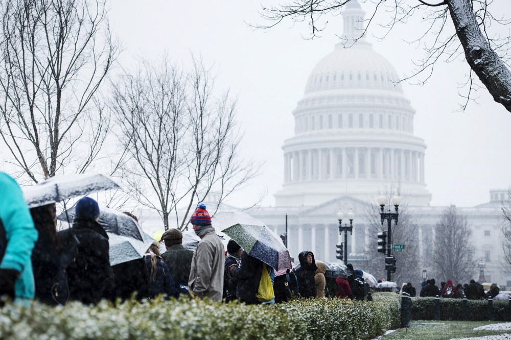 People stand outside the US Supreme Court, Mar. 25, 2014.