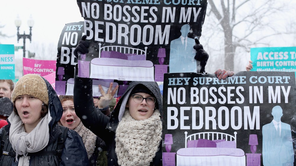 Demonstrators rally outside of the U.S. Supreme Court during oral arguments in Sebelius v. Hobby Lobby March 25, 2014 in Washington, D.C.