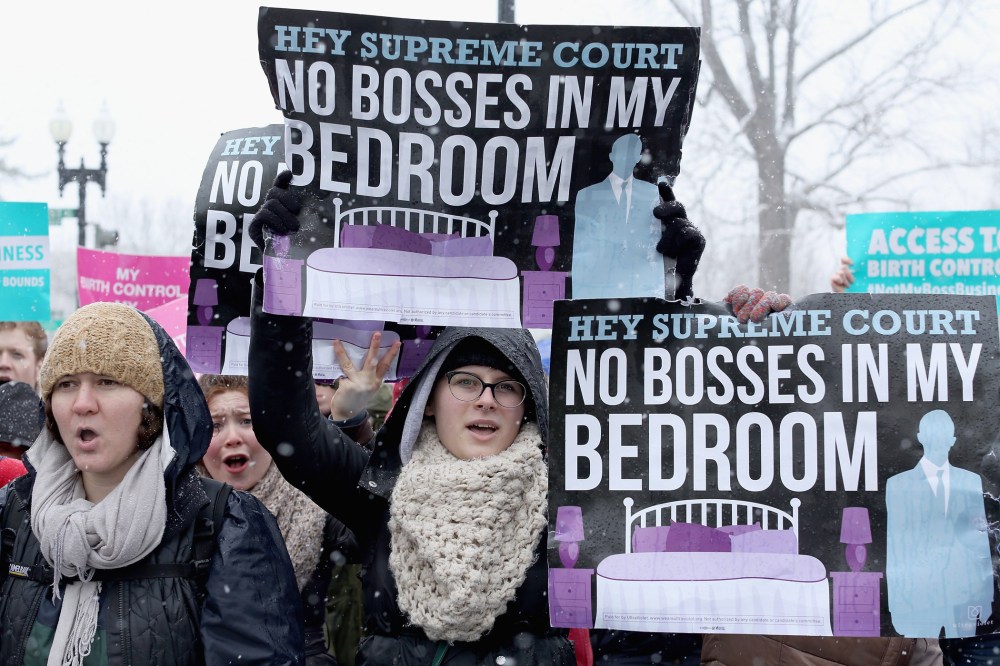 Demonstrators rally outside of the U.S. Supreme Court during oral arguments in Sebelius v. Hobby Lobby March 25, 2014 in Washington, D.C.